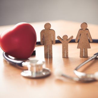 cutouts of family with heart-shaped stress ball and stethoscope